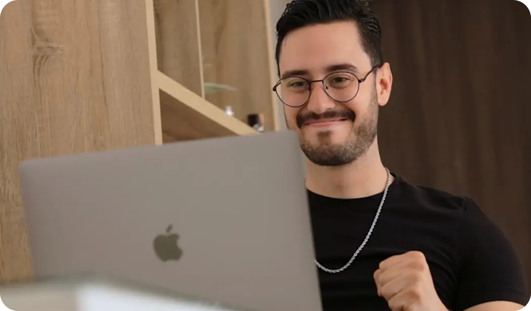 Client smiling behind a laptop